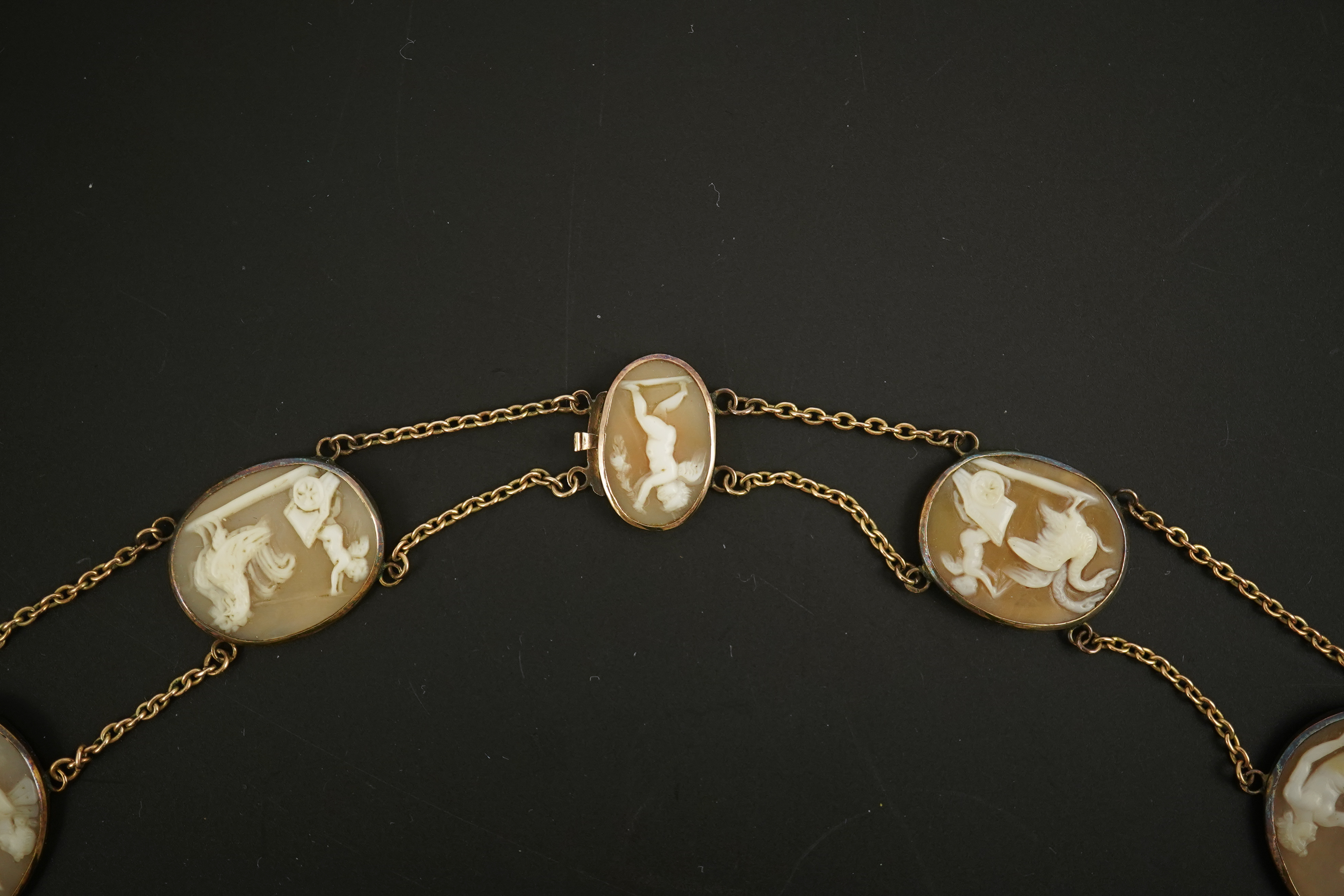 An early 19th century Italian Grand Tour gold double chain link and ten graduated oval cameo shell set necklace